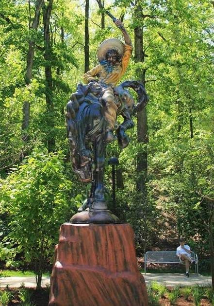 Cowboy Statue on Rearing Horse in Park
